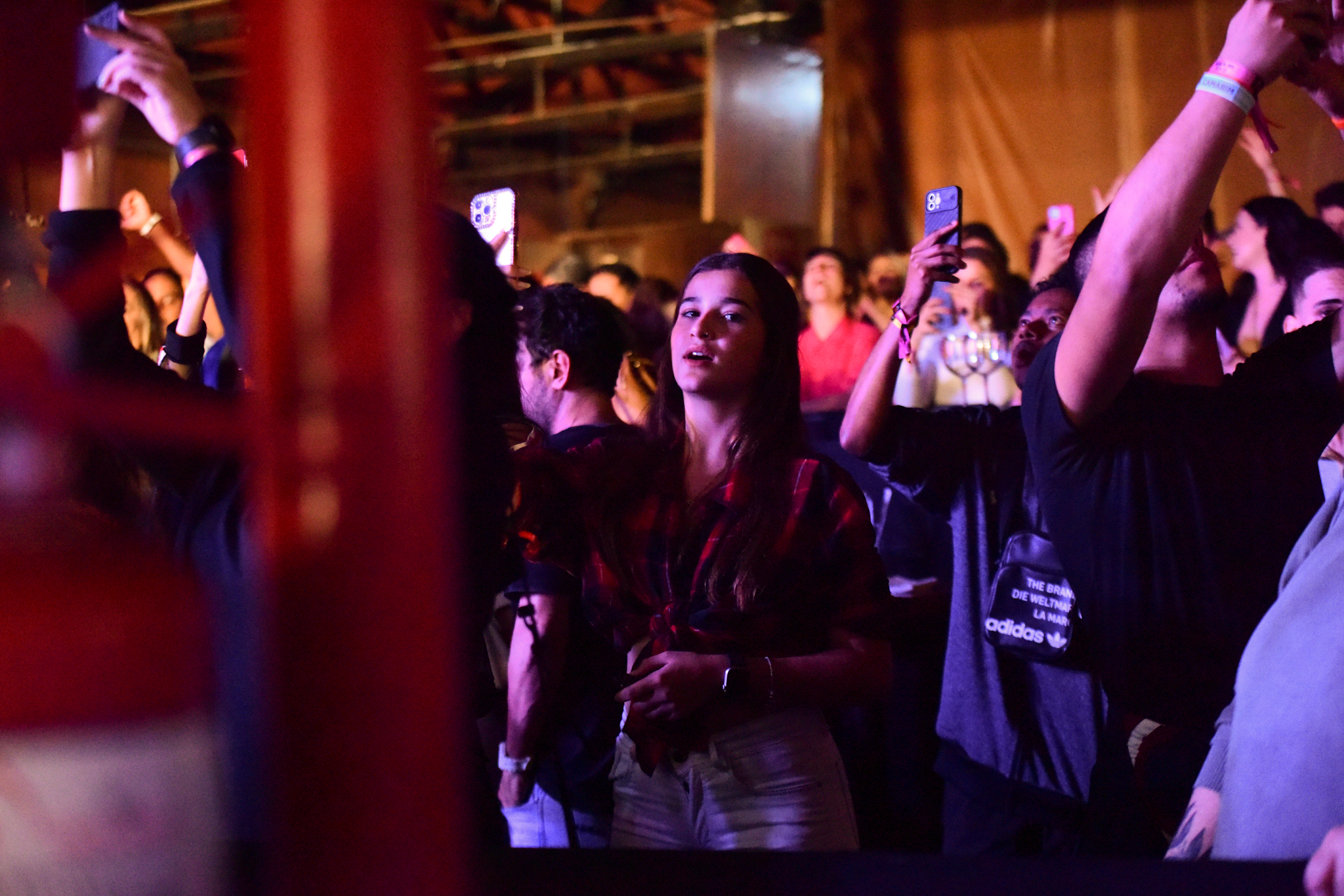 Foto de Duda Wendling olhando para a câmera enquanto assiste show de João Gomes