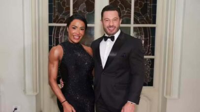 Gracyanne Barbosa e Belo posam em evento com trajes de gala. A musa fitness usa vestido preto brilhante e o cantor, um terno.