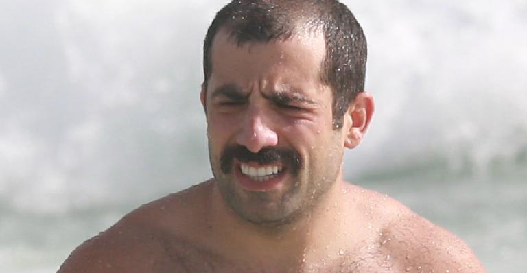 Ex-BBB Kaysar Dadour aparece bigodudo e ostenta corpo malhado na praia