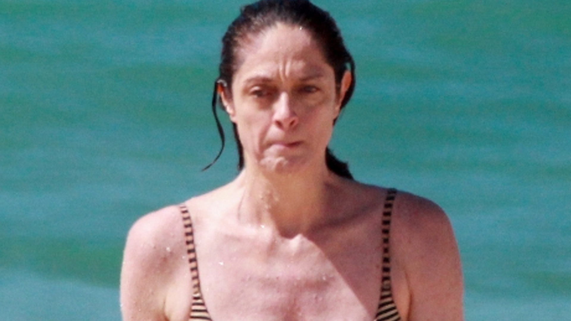 Discreta, Bianca Byington faz rara aparição de biquíni na praia aos 55 anos