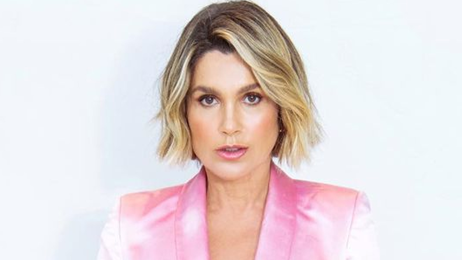 Flávia Alessandra dispensa sutiã e abre terninho: “Show de beleza”